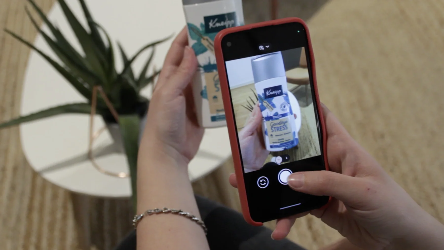 A consumer photographing a product with their phone to write a review