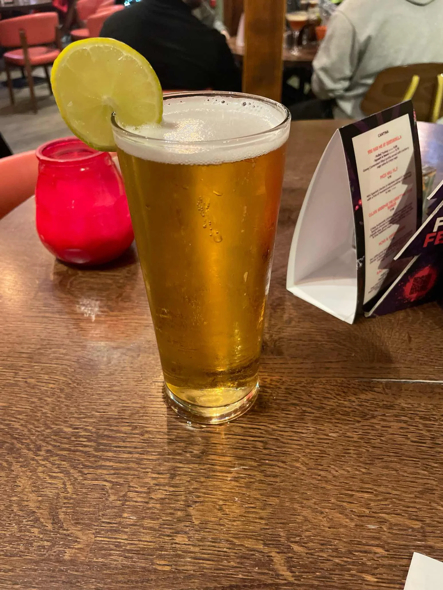 Beer served with a round lime wheel on the rim instead of the specified lime wedge